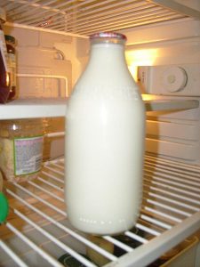 Glass Milk bottle kept for cooling in the refrigerator